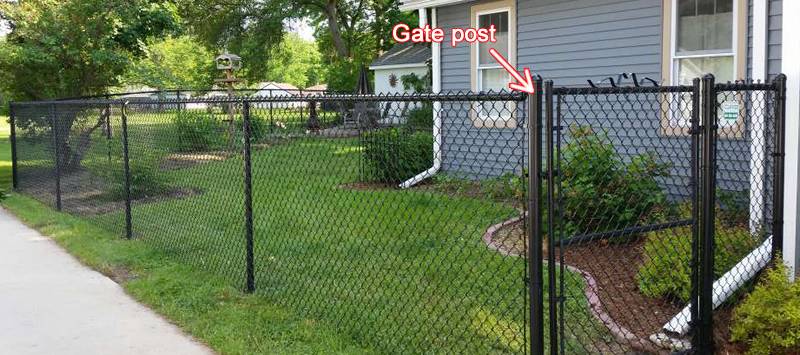 Black gate post of 6-feet high chain link fencing.