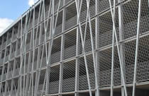 Stainless steel cable mesh are mounted to the outside of a building as facades for encourage plant growth.