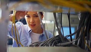 Female IT professional checking wire connections