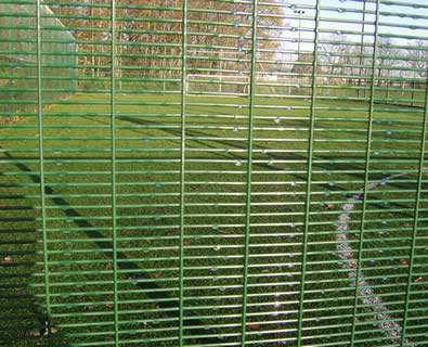 Green powder coated anti-climb 358 fence encloses football court