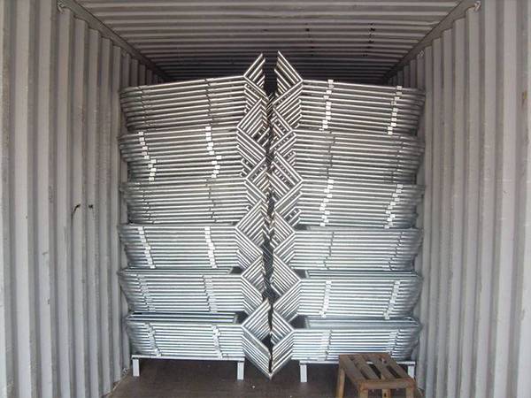 Several bundles of crowd control barriers are stacking in the container.
