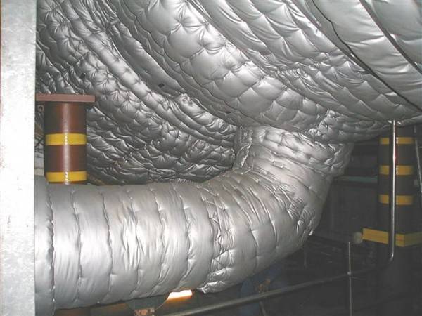 Pipes covered with small chain link fence inside for thermal insulation