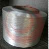 Polyester modified filament yarn with low shrinkage medium intensity filament