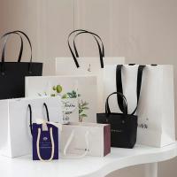 China Custom Luxury Cosmetic Paper Bags Clothing Shopping Bags With Handles on sale