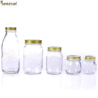 China Carved Flower Honey Glass Jar And Spoon Transparent Honey Container on sale