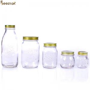 China Carved Flower Honey Glass Jar And Spoon Transparent Honey Container supplier