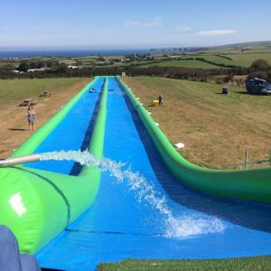 China 100m Giant Inflatable Slip N Slide With Pool For Kids And Adults supplier