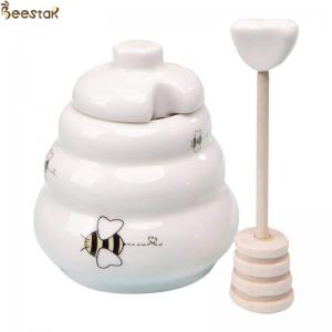 China Wholesale White Empty Honey Jar Ceramic Honey Pot with wooden dipper for honey storage supplier