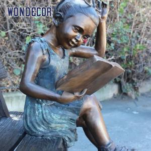 China Custom Life Size A bronze statue of a girl sitting on a bench reading a book supplier