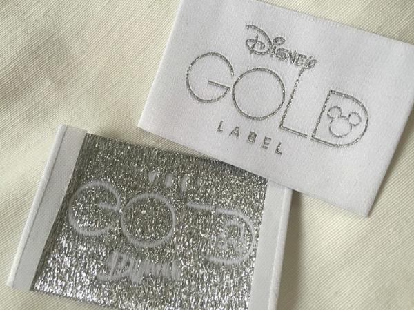 L'habillement tissé par pli d'extrémité de Bage d'or de Disney marque la coupe