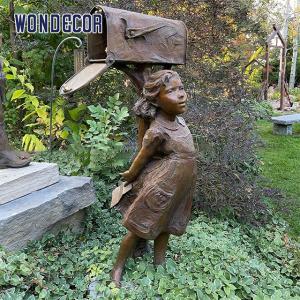 Little Girl Under A Copper Sculpture Metal Decorated Mailbox In Garden Courtyard