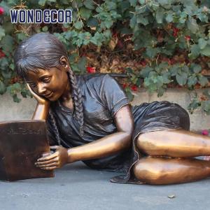 Customized garden decoration, life-size bronze statue of a girl lying on her side reading a book